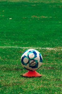 Vibrant soccer ball on a green field in Tlaxcala, Mexico, perfect for sports enthusiasts.